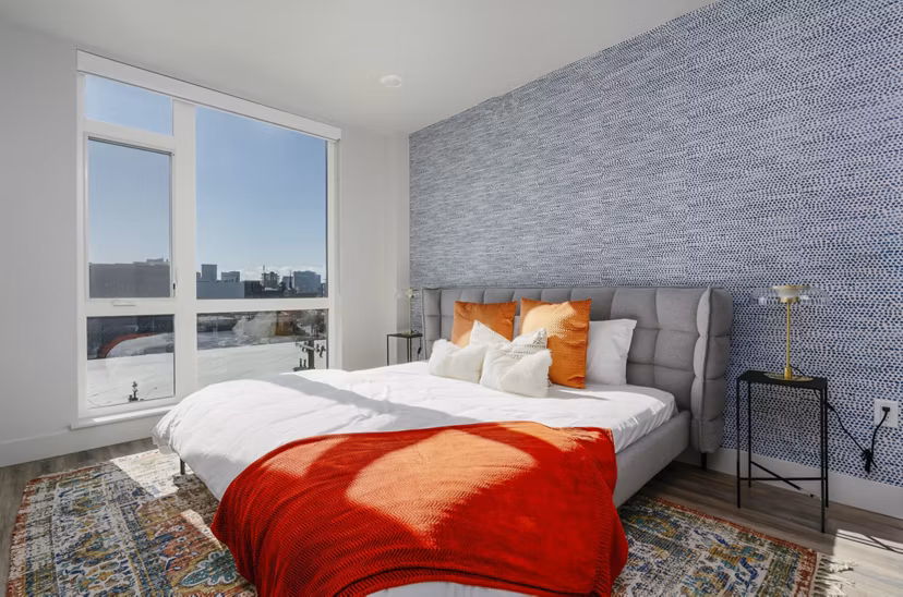 Cozy bedroom with modern decor at Assembly Apartments
