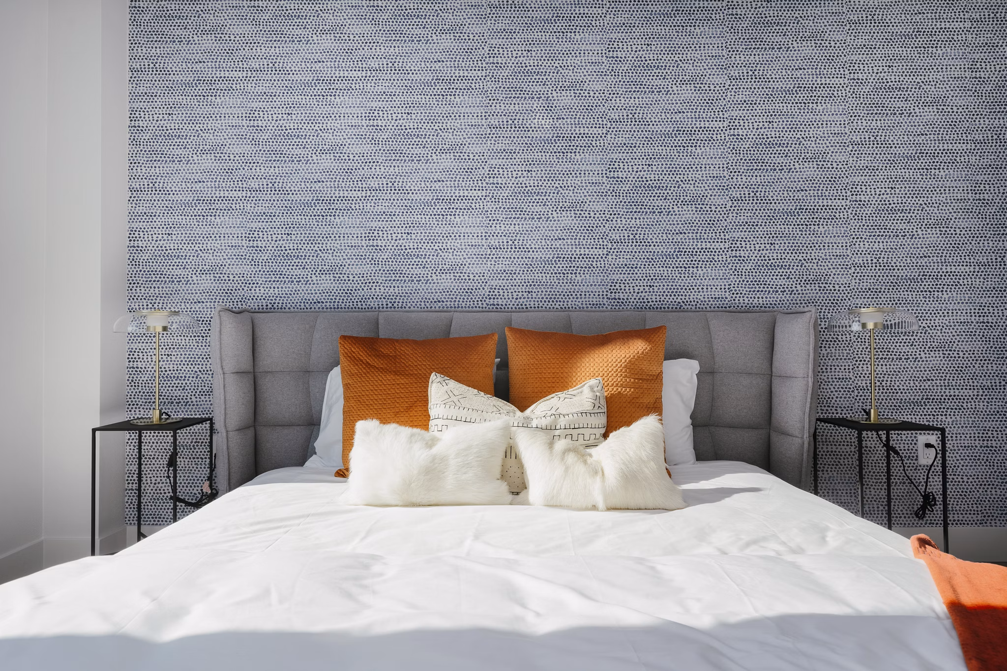 Cozy bedroom featuring plush bedding and modern decor at Assembly Apartments