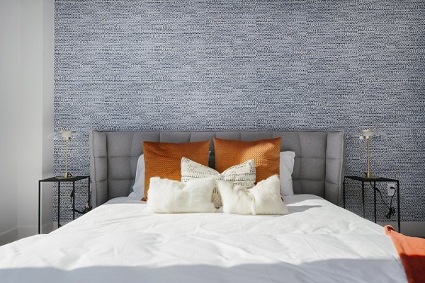 Cozy bedroom featuring plush bedding and modern decor at Assembly Apartments