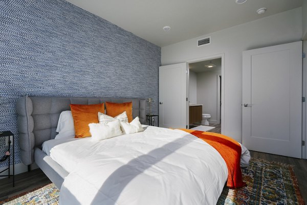 Cozy bedroom with modern decor at Assembly Apartments