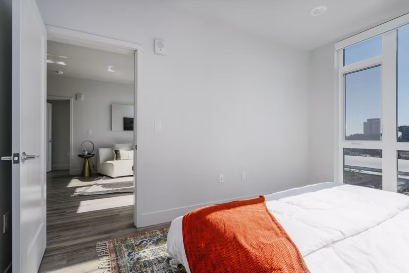 Cozy bedroom with modern furnishings at Assembly Apartments: Luxury living with serene ambiance
