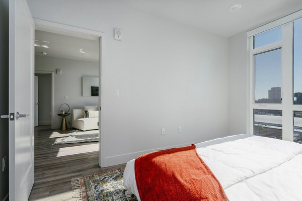 Cozy bedroom with modern furnishings at Assembly Apartments: Luxury living with serene ambiance