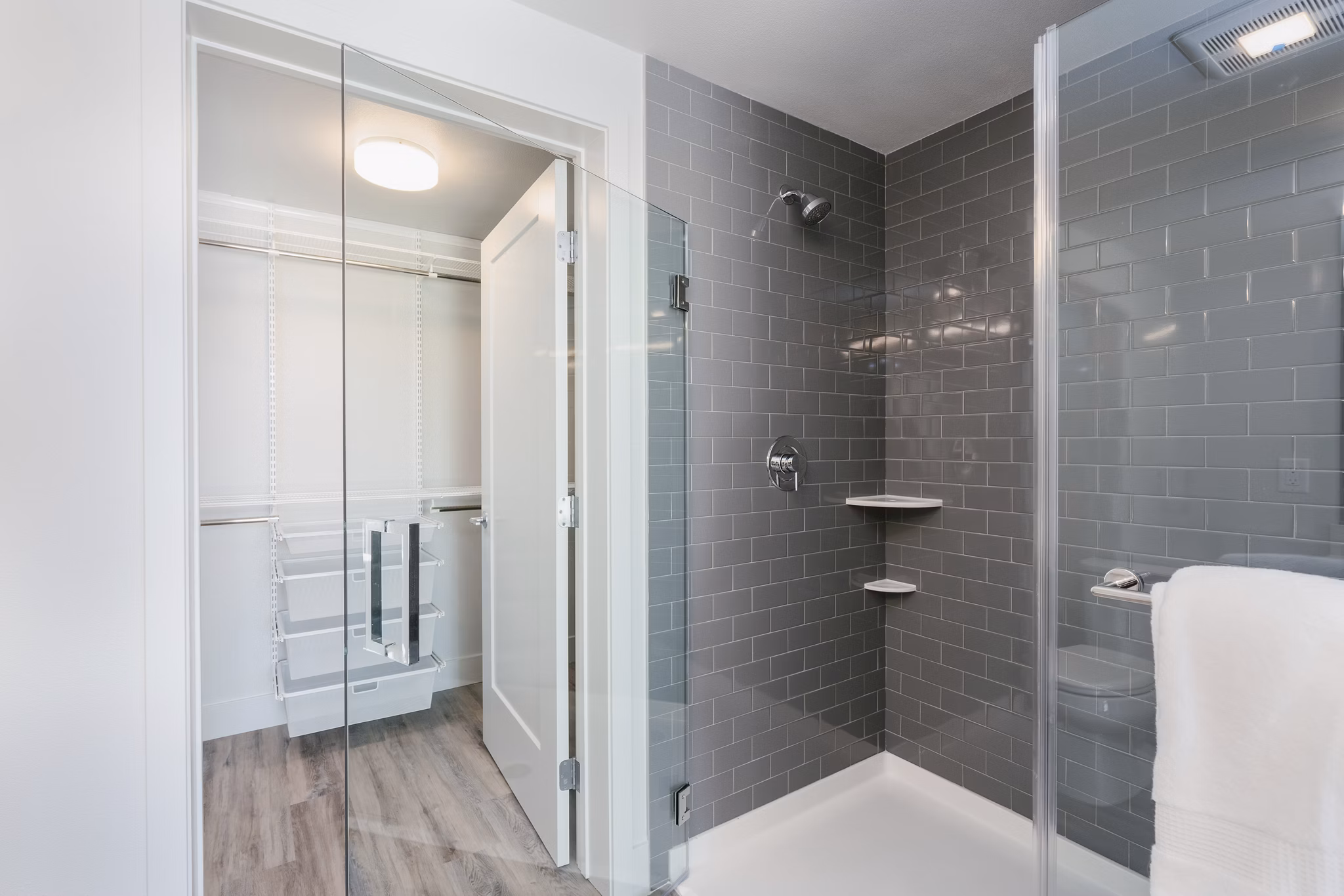 Modern bathroom featuring sleek fixtures and ample storage space in Assembly Apartments