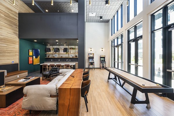 Clubhouse with modern decor and seating at Assembly Apartments Ideal for social gatherings and relaxation in a welcoming community space