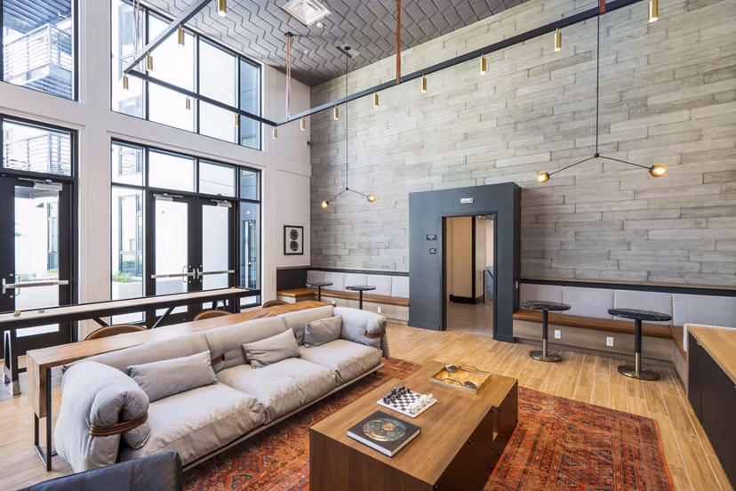 Clubhouse with modern seating and entertainment area at Assembly Apartments, luxury living by Greystar