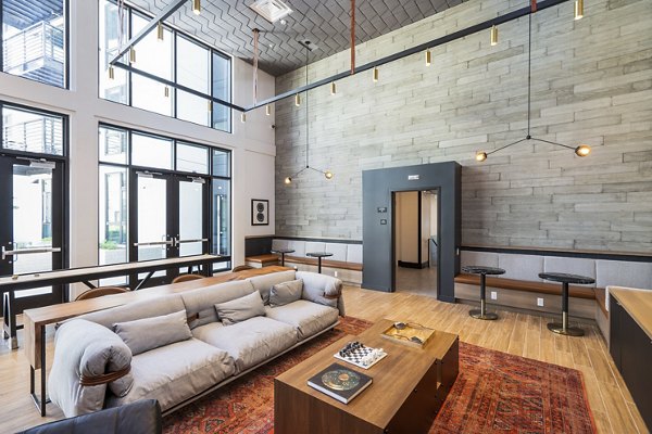 Clubhouse with modern seating and entertainment area at Assembly Apartments, luxury living by Greystar