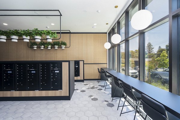 Clubhouse with contemporary design and seating at Assembly Apartments in upscale community, ideal for social gatherings and relaxation
