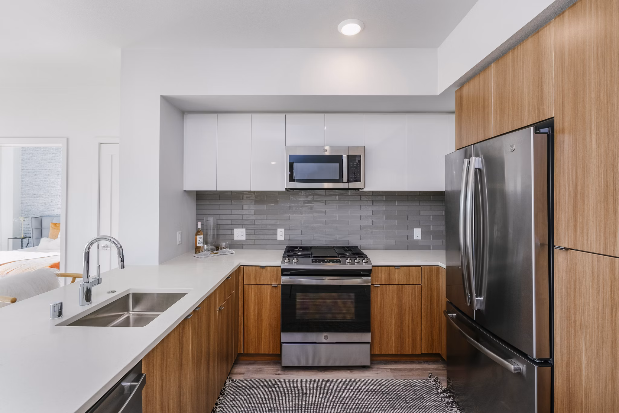 Spacious kitchen featuring modern appliances in Assembly Apartments luxury residence