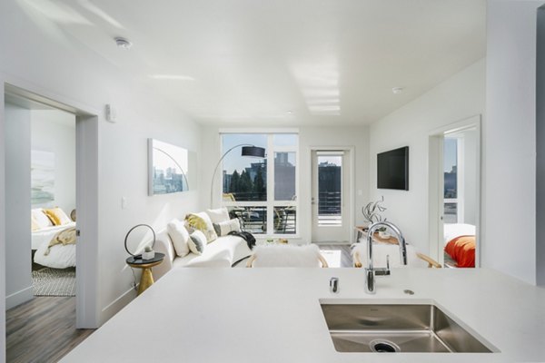 Assembly Apartments: Modern kitchen with stainless steel appliances in a luxury setting