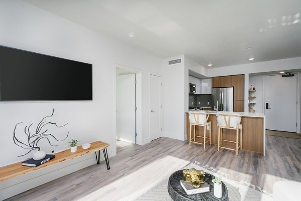 Spacious living room with elegant furnishings at Assembly Apartments, showcasing luxury living in a prime location
