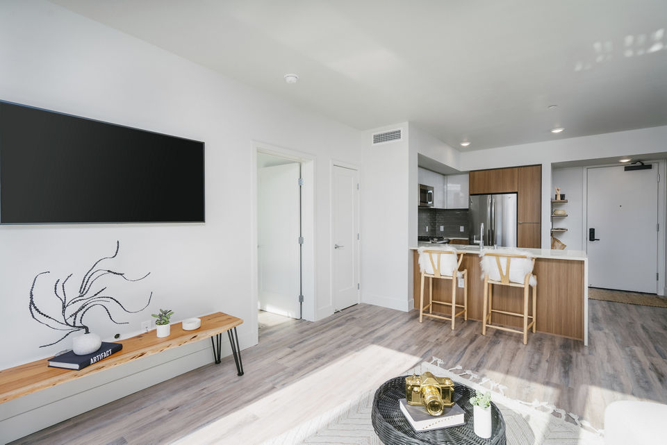 Spacious living room with elegant furnishings at Assembly Apartments, showcasing luxury living in a prime location