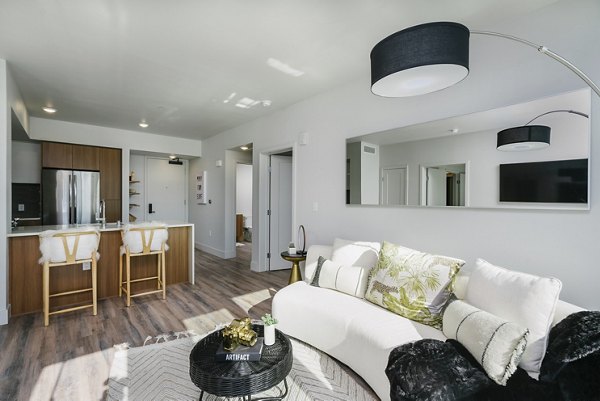 Cozy living room with modern decor and natural light at Assembly Apartments
