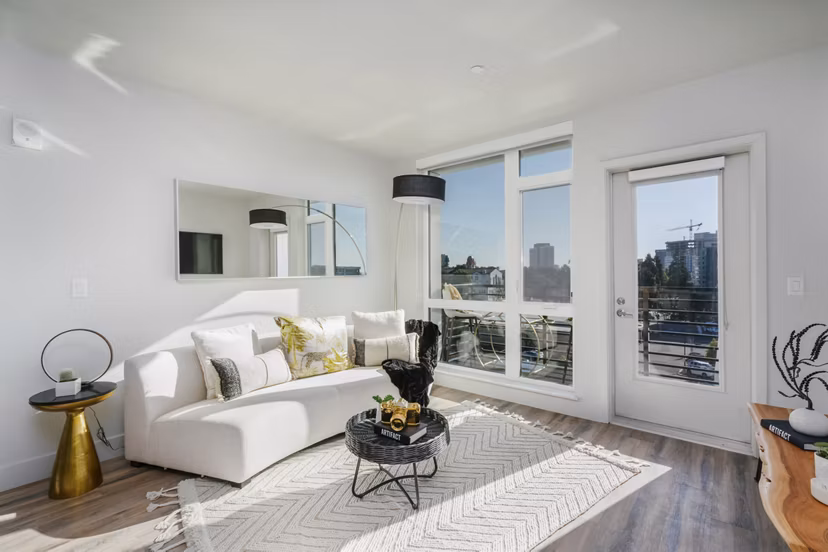 Modern living room with stylish decor and natural light in Assembly Apartments