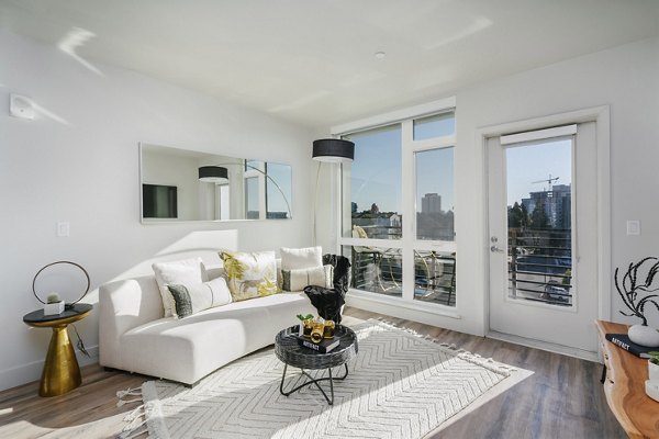Modern living room with stylish decor and natural light in Assembly Apartments