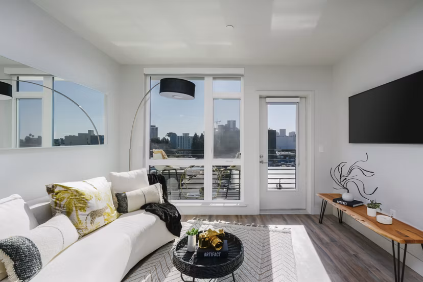Spacious living room with modern furnishings and natural light at Assembly Apartments, luxury community by Greystar