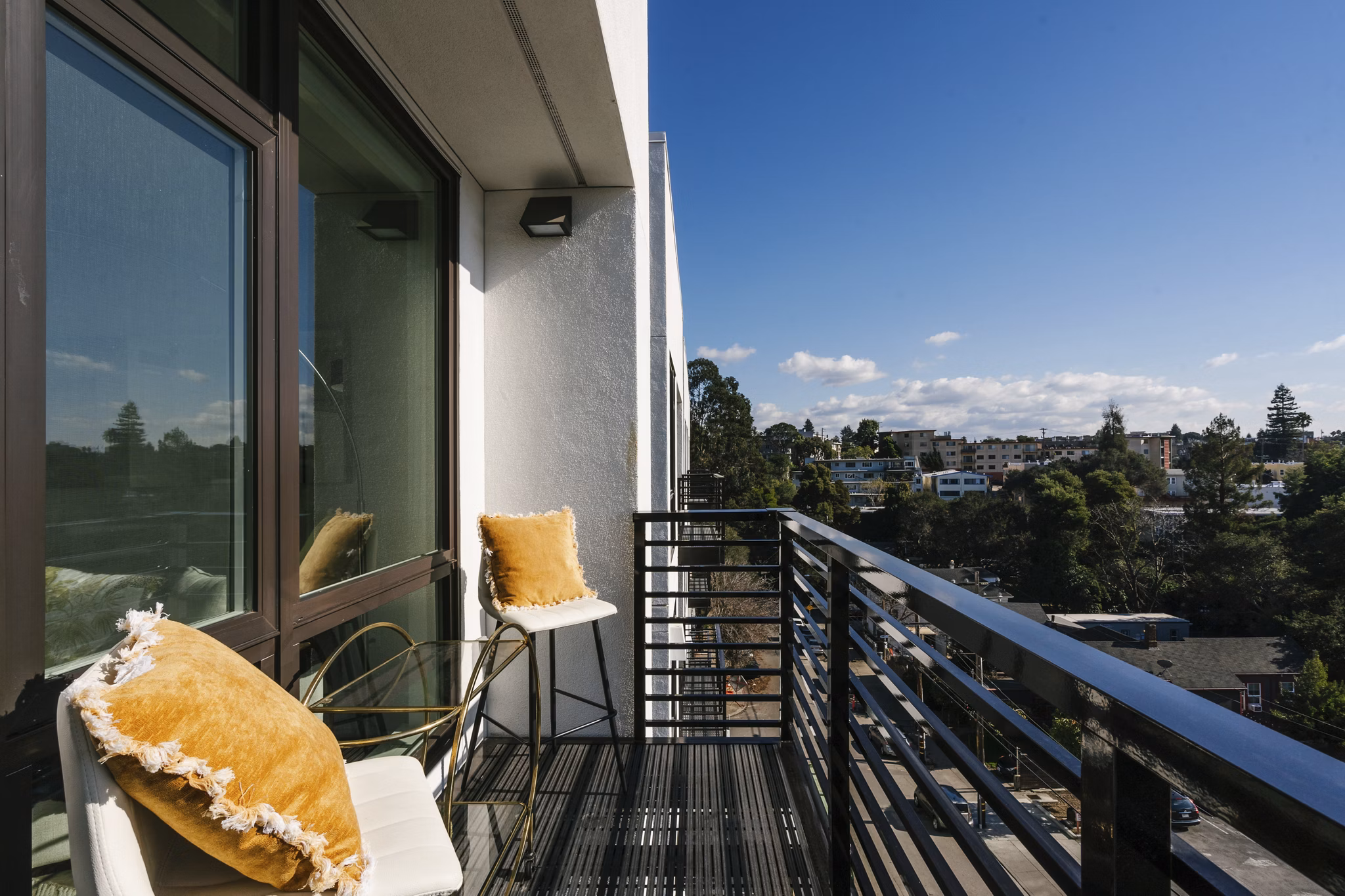 Cozy outdoor patio at Assembly Apartments with modern seating and lush plants, perfect for relaxation in a serene environment