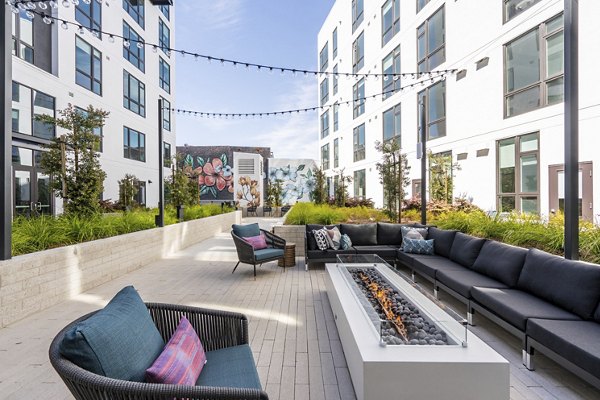 Fire pit lounge area at Assembly Apartments with cozy seating and ambient lighting, perfect for relaxation and social gatherings