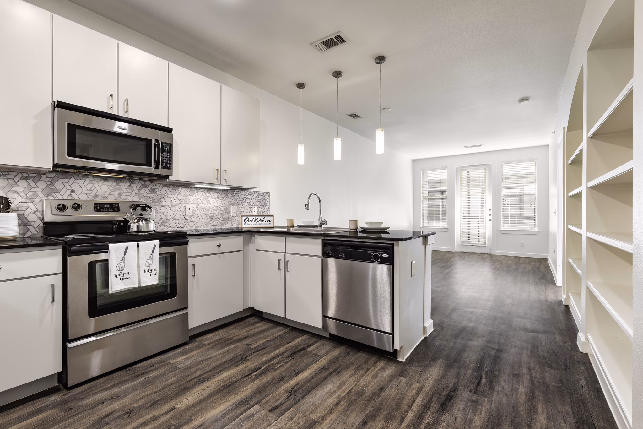 Modern kitchen with sleek countertops and stainless steel appliances in Crescent Apartments