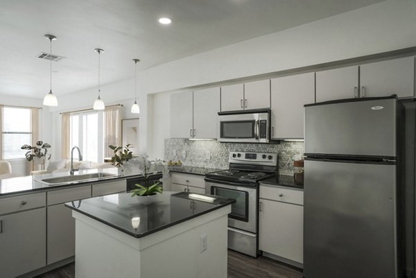 Modern kitchen with stainless steel appliances at Crescent Apartments