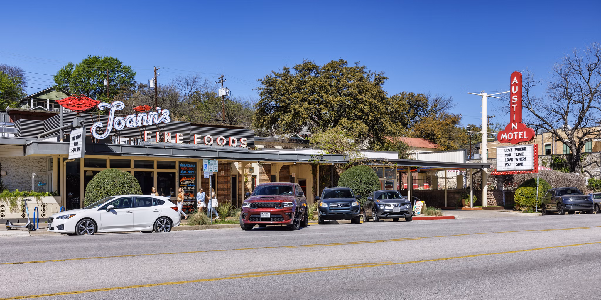 Joann's Fine Foods with outdoor seating next to the vibrant Austin Motel