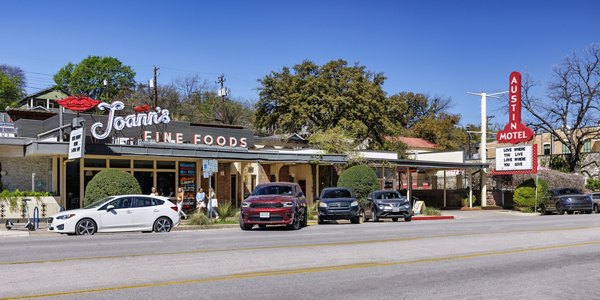 Joann's Fine Foods with outdoor seating next to the vibrant Austin Motel