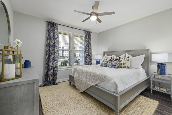 Cozy bedroom with modern furnishings at Element Barclay Station luxury apartments