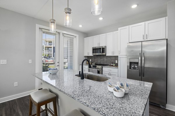 Modern kitchen with stainless steel appliances at Element Barclay Station apartments