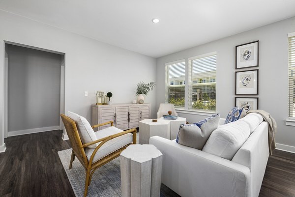 Living room with modern furnishings and ample natural light at Element Barclay Station luxury apartments