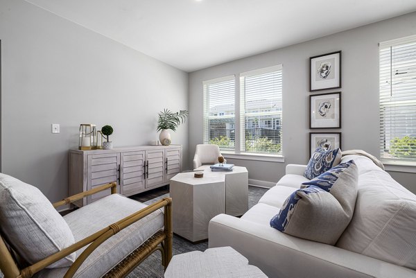 Living room with modern furnishings and natural light at Element Barclay Station luxury apartments