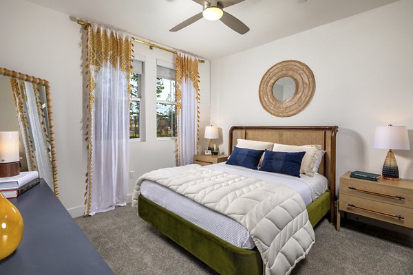 Cozy bedroom with modern furnishings and ample natural light at Citron Apartments