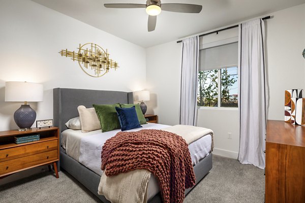 Bedroom featuring contemporary decor and large windows at Citron Apartments
