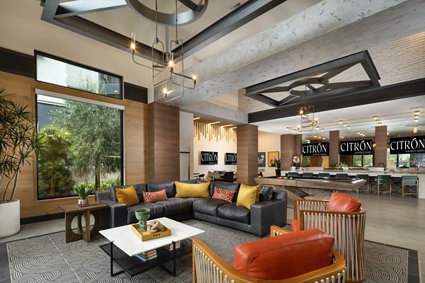Citron Apartments: Modern clubhouse with lounge seating and entertainment options in luxury Greystar community