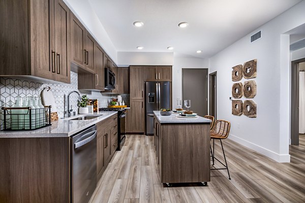 Contemporary kitchen with stainless steel appliances at Citron Apartments