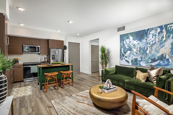 Modern living room with stylish furnishings and natural light in Citron Apartments