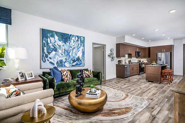 Contemporary living room featuring stylish furnishings and natural light at Citron Apartments