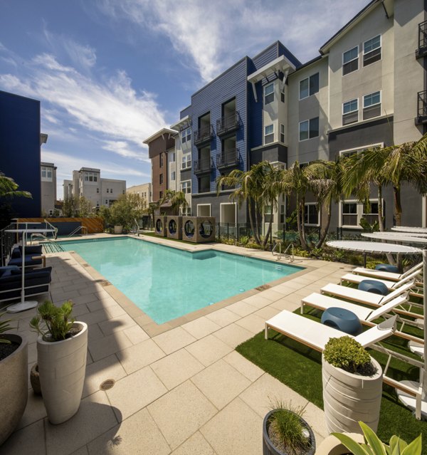 Relaxing poolside cabanas and crystal-clear water at Citron Apartments, offering luxury living in a vibrant community setting