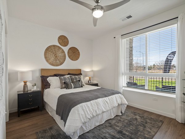 Spacious bedroom with modern decor at Fieldhouse Apartments, featuring soft lighting and ample wardrobe space