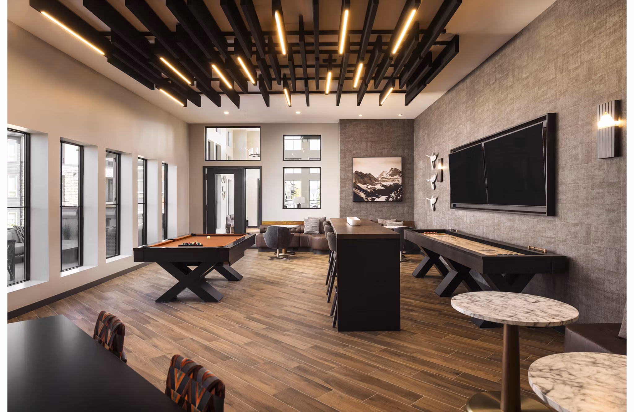 Fieldhouse Apartments: Stylish clubhouse featuring modern decor and comfortable seating areas in an upscale community setting