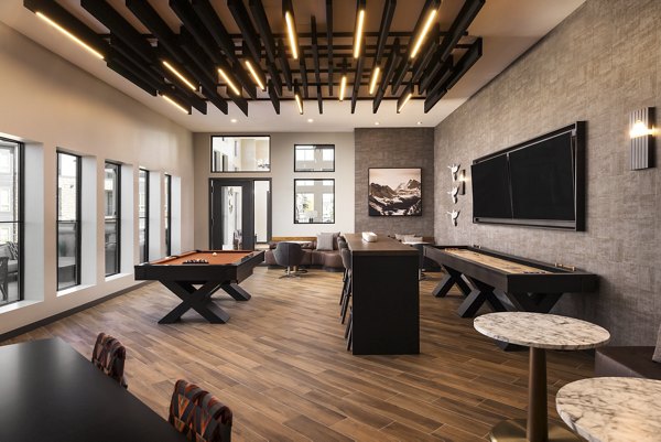 Fieldhouse Apartments: Stylish clubhouse featuring modern decor and comfortable seating areas in an upscale community setting