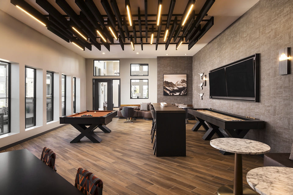 Fieldhouse Apartments: Stylish clubhouse featuring modern decor and comfortable seating areas in an upscale community setting