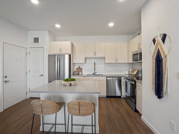 Modern kitchen with sleek cabinetry and stainless steel appliances in Fieldhouse Apartments