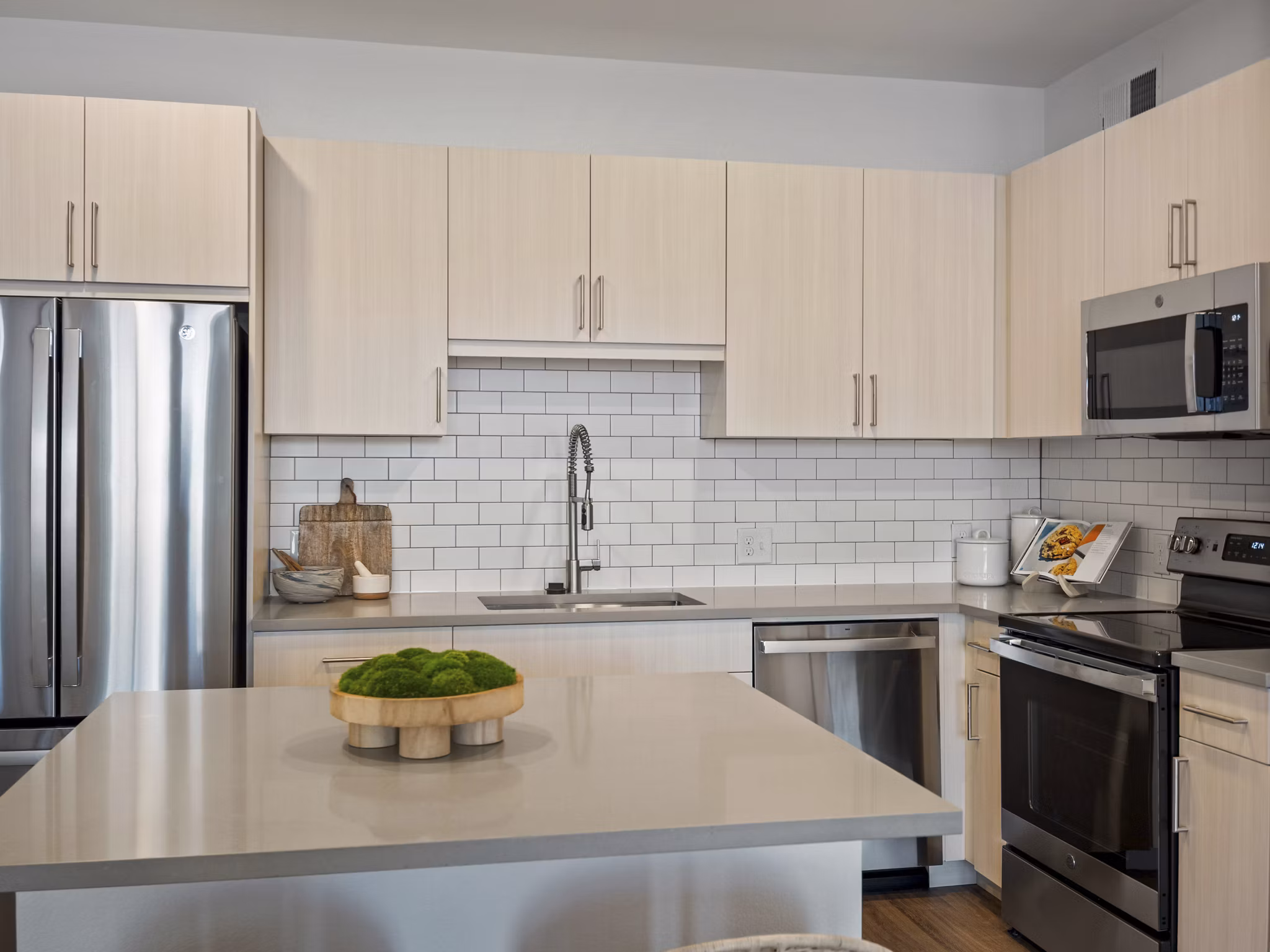 Modern kitchen with stainless steel appliances in Fieldhouse Apartments