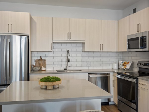 Modern kitchen with stainless steel appliances in Fieldhouse Apartments