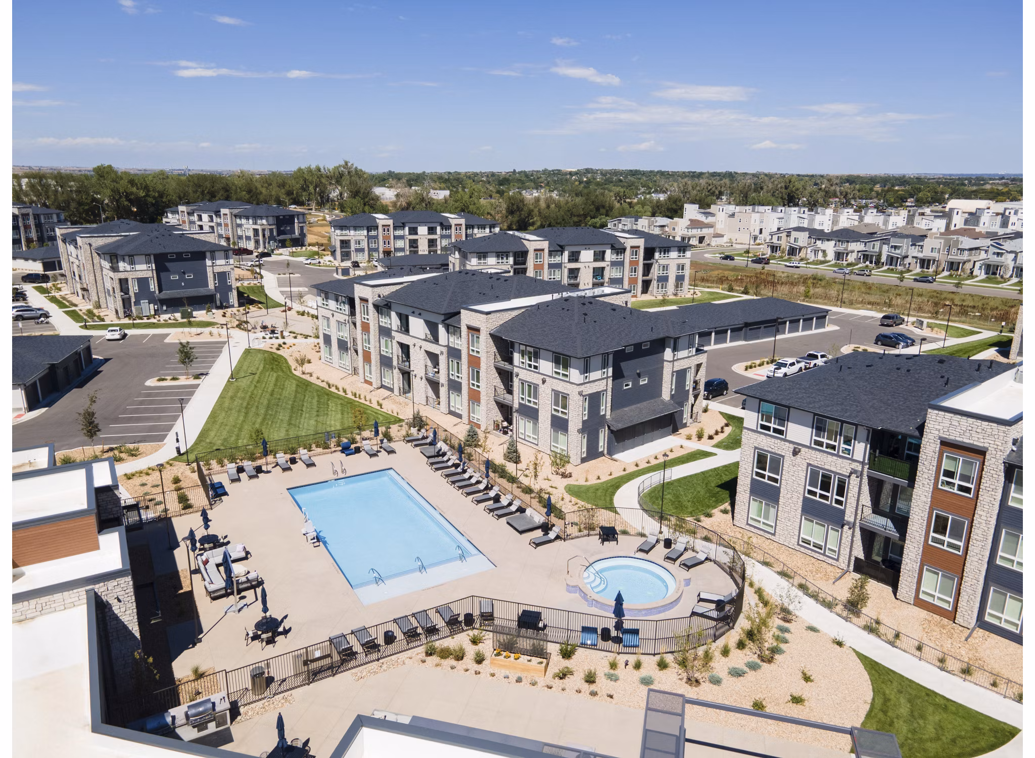 Outdoor pool with lounge chairs at Fieldhouse Apartments offers relaxation and recreation