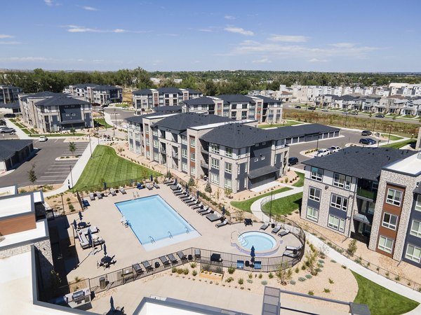 Outdoor pool with lounge chairs at Fieldhouse Apartments offers relaxation and recreation