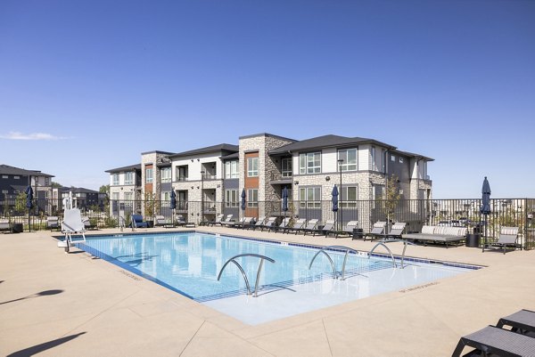 In sunny pool area at Fieldhouse Apartments, by Greystar