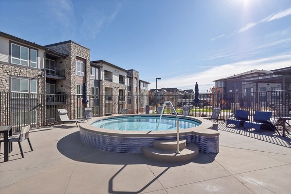 Modern poolside lounging area at Fieldhouse Apartments offering luxury relaxation amenities