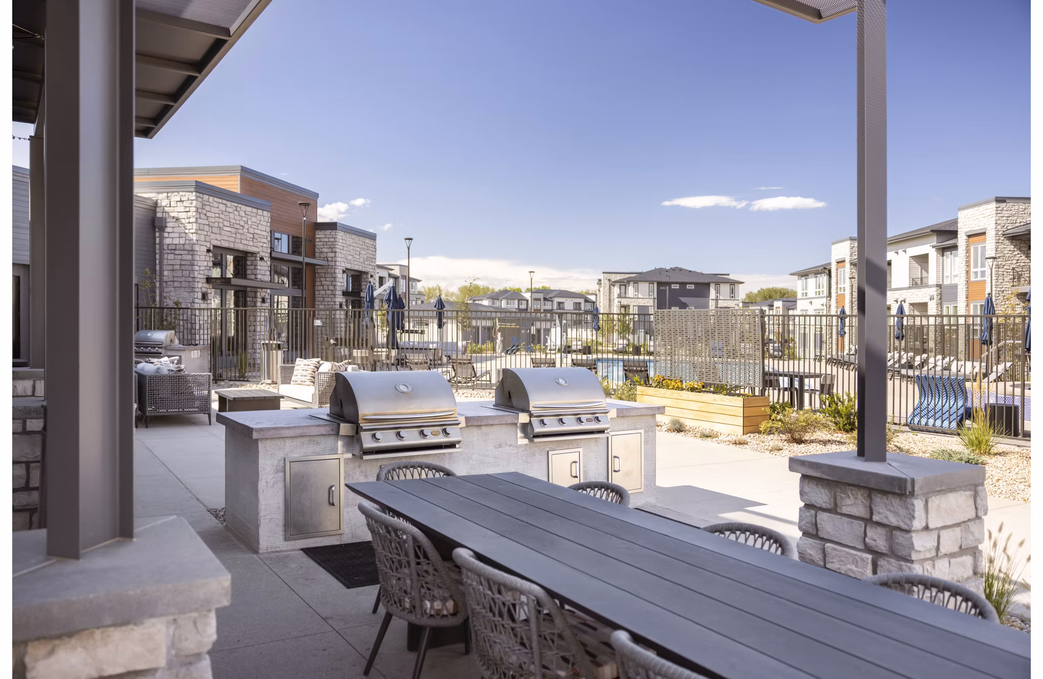 Outdoor grill area at Fieldhouse Apartments featuring modern BBQ stations