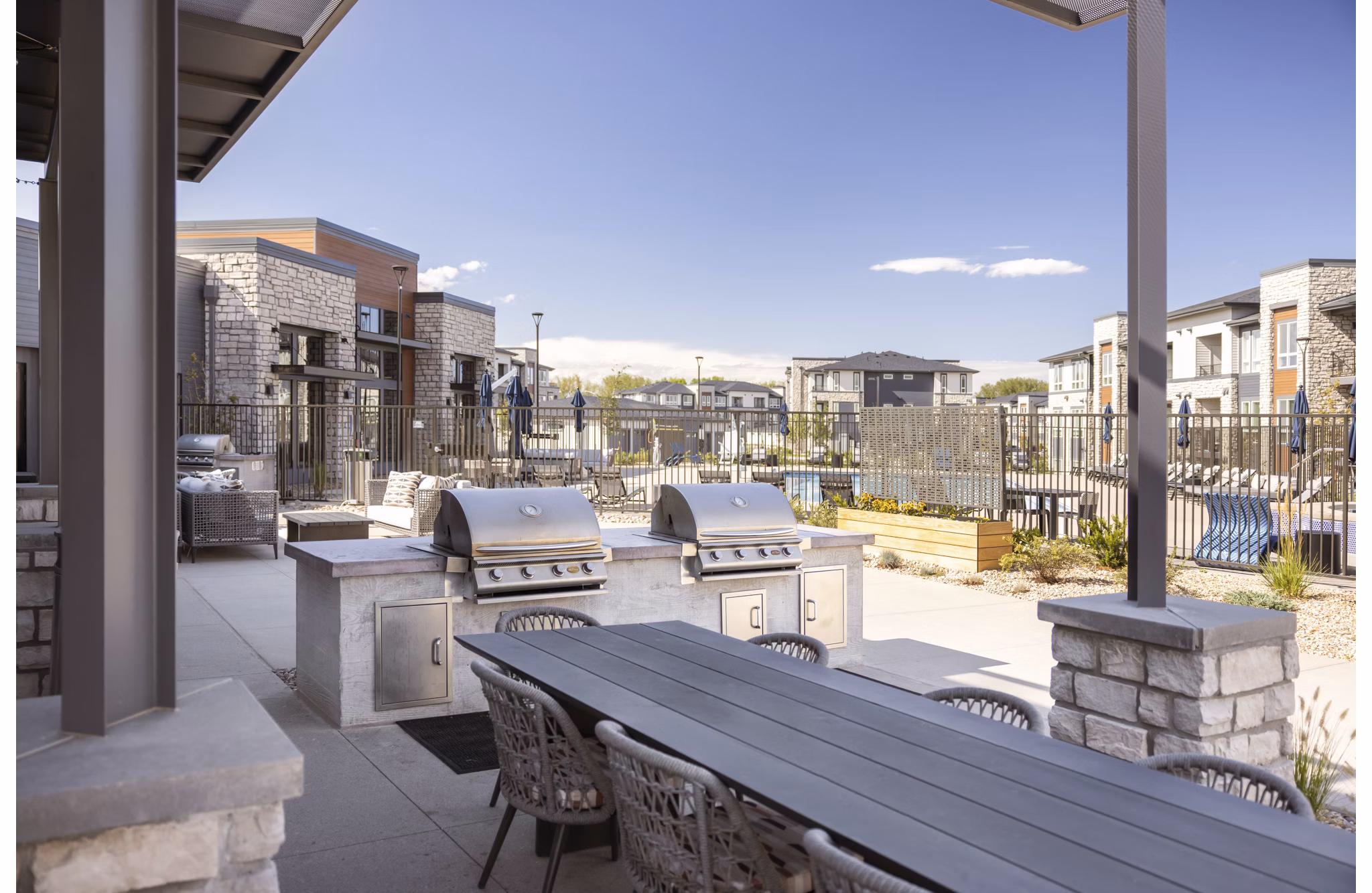 Outdoor grill area at Fieldhouse Apartments featuring modern BBQ stations