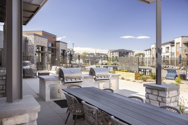 Outdoor grill area at Fieldhouse Apartments featuring modern BBQ stations